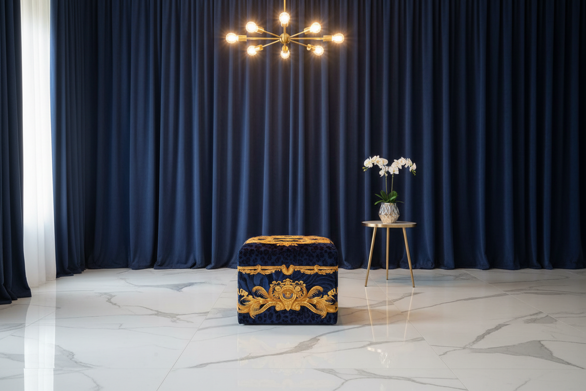 Luxury Custom Ottoman in Versace DV Wild Animal Print blue velvet styled in a contemporary luxury living room with white marble floors, navy velvet curtains and gold chandelier — Fine et Flair