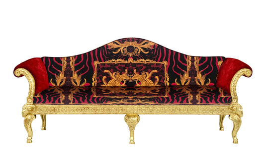 A luxury 3-seater sofa with a solid wood frame covered in Versace Zahara Leopard Red Fabric with gold leaf finish and elaborate ram's head carvings.