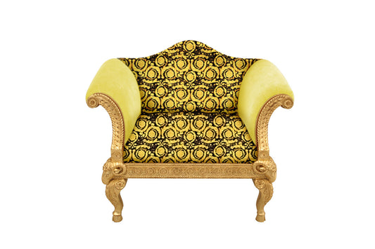 A single-seater sofa with a gold leaf finish and a Versace vanity barocco pattern in black and gold.
