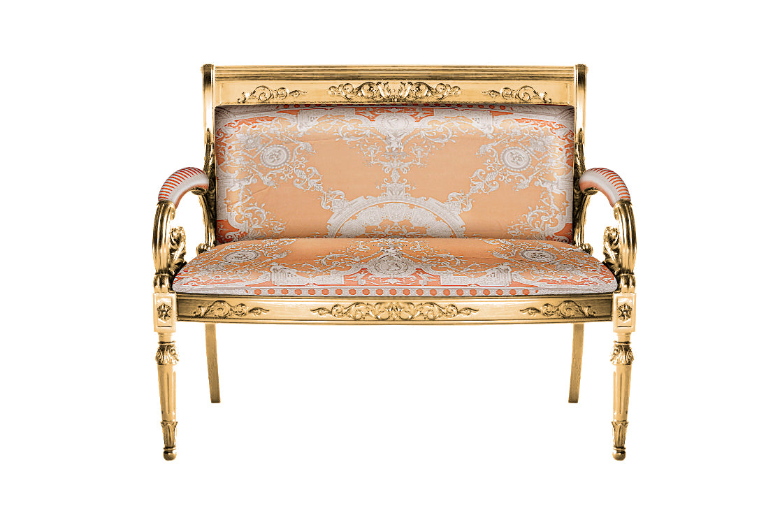 A 2-seater loveseat with orange upholstery and gold-colored frame featuring intricate carvings and a vanitas design.